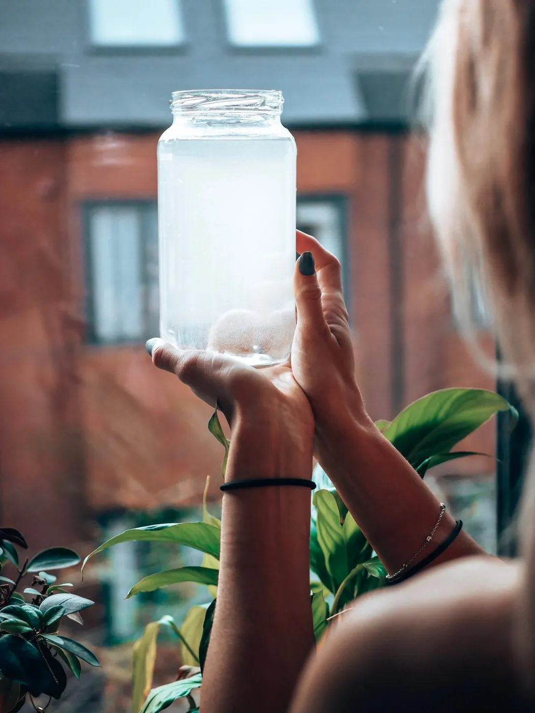 A glass of ionised water held up to the light